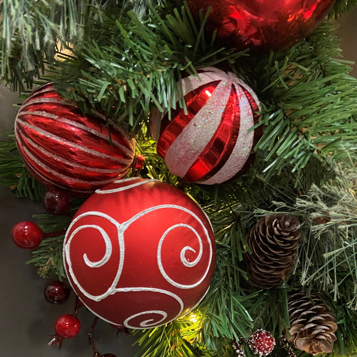 Haute Decor 26 Inch Holiday Times Wreath with Patterned Red and White Shatterproof Ornaments, Berries, and Real Pinecones