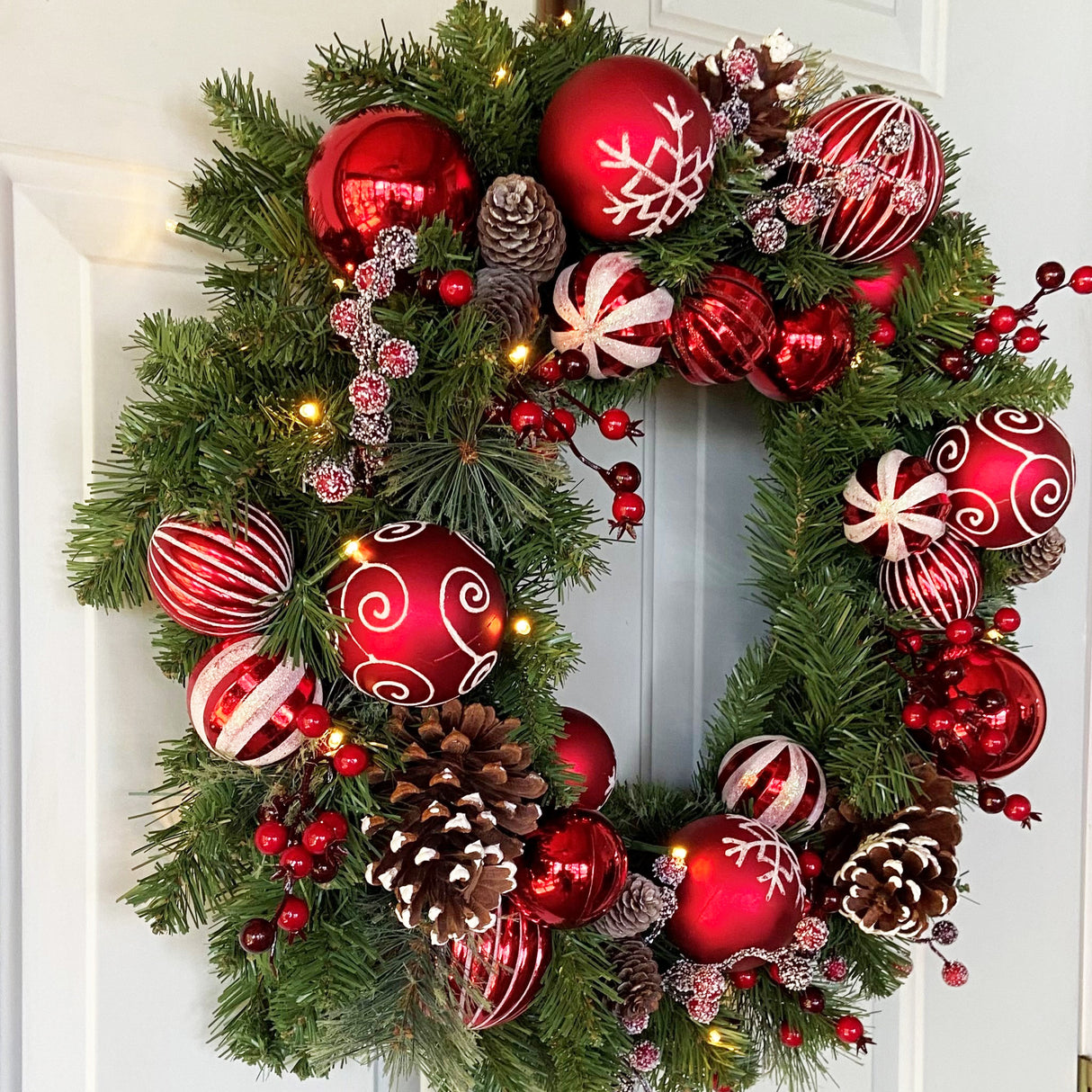Haute Decor 26 Inch Holiday Times Wreath with Patterned Red and White Shatterproof Ornaments, Berries, and Real Pinecones