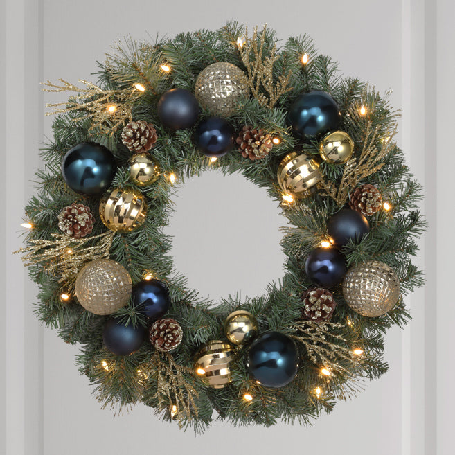 Haute Decor 24 Inch Sutton Place Christmas Wreath with Soft White LED Lights on Automatic Timer - Pre-Lit Christmas Wreath Featuring Blue and Gold Shatterproof Ornaments